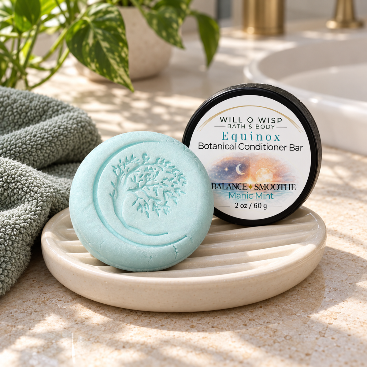 WILL O WISP BATH & BODY Equinox botanical conditioner bar in light blue with tree embossing on a ceramic soap dish.