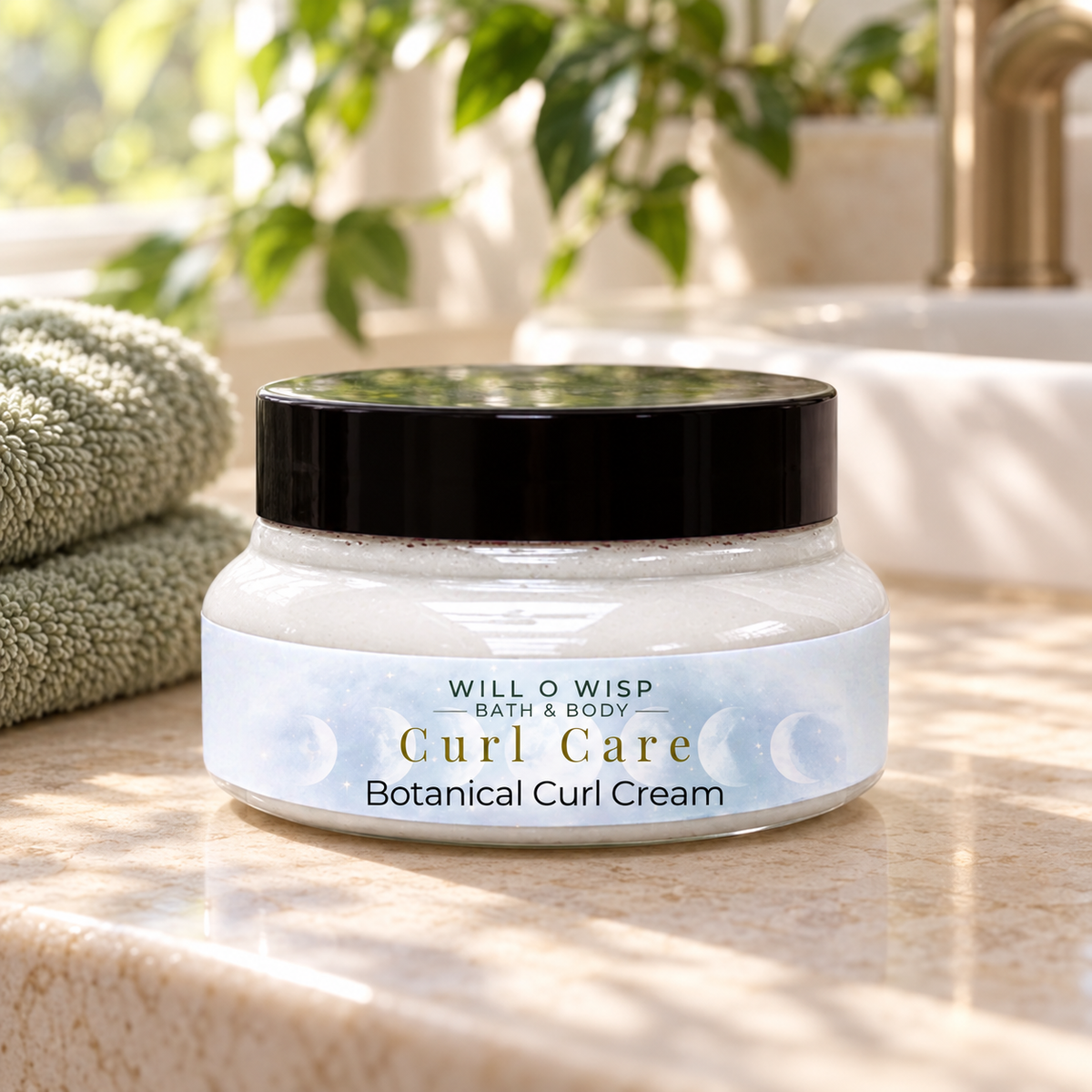 WILL O WISP BATH & BODY Curl Care botanical curl cream in a glass jar on a marble countertop with a green towel.