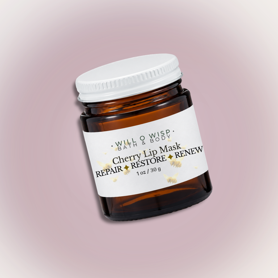 WILL O WISP BATH & BODY cherry lip mask in a small amber glass jar with a white lid on a soft pink background.