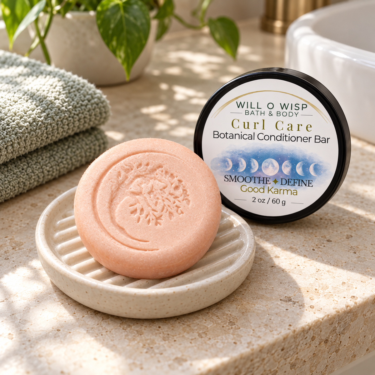 WILL O WISP BATH & BODY Curl Care botanical conditioner bar on a ceramic dish with its product tin in a bathroom.