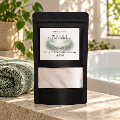 WILL O WISP BATH & BODY Herbal Ease bath soak pouch with CBD, glucosamine, and MSM on a stone ledge by a bathtub.